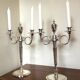Pair of silver-plated metal candelabra decorated with hunting horns