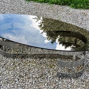 Oval coffee table of the 70s chromed metal base in s smoked glass top