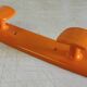 Orange plastic coat rack by Syla - 70's