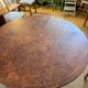 Oval extendable dining table in wood and walnut burl veneer.