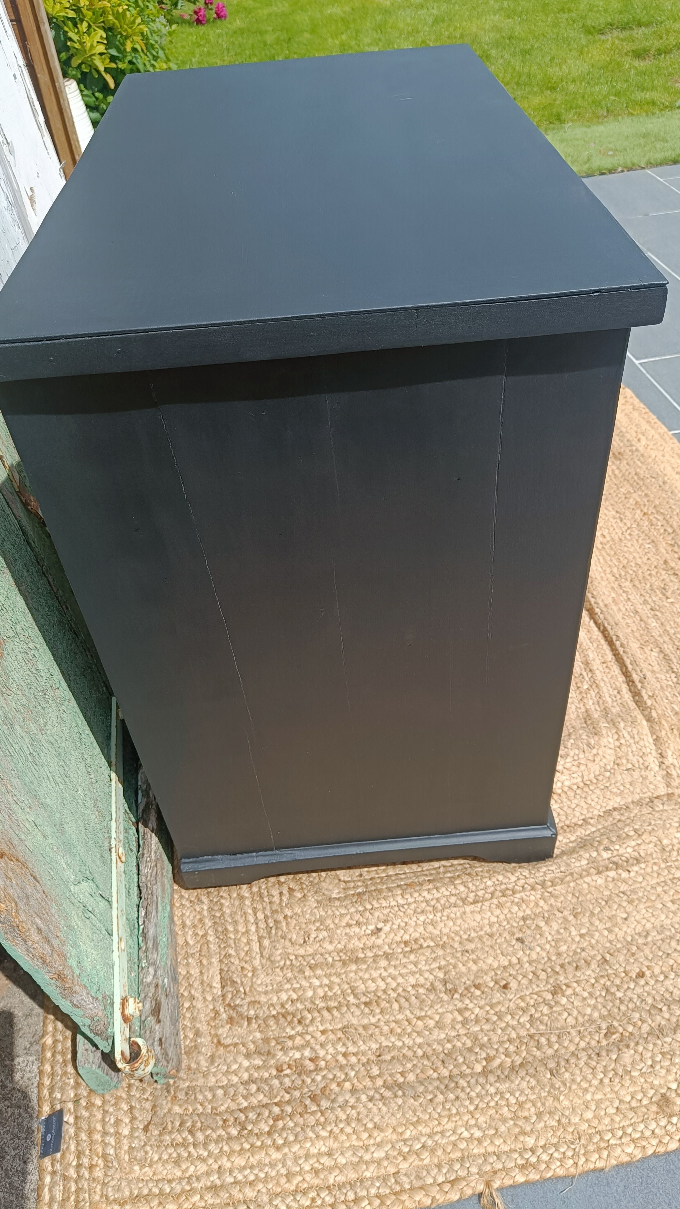 Vintage commode revamped in matte black & wood with warm tones.