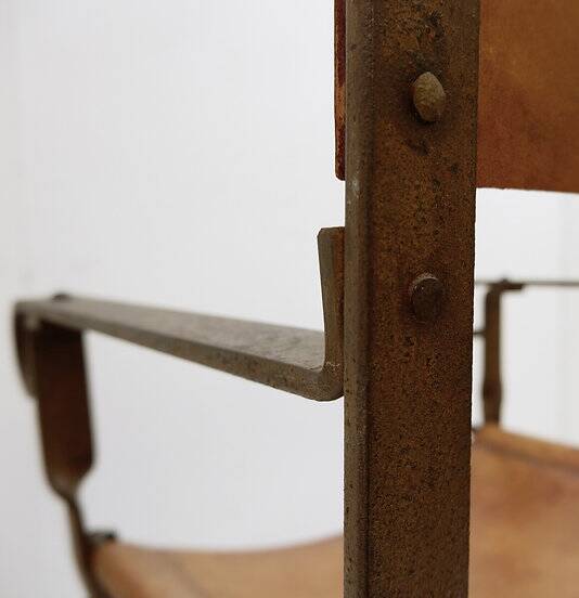 Curule armchair in wrought iron and leather