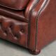 Cowhide chesterfield armchair in a warm brown colour with decorative nails