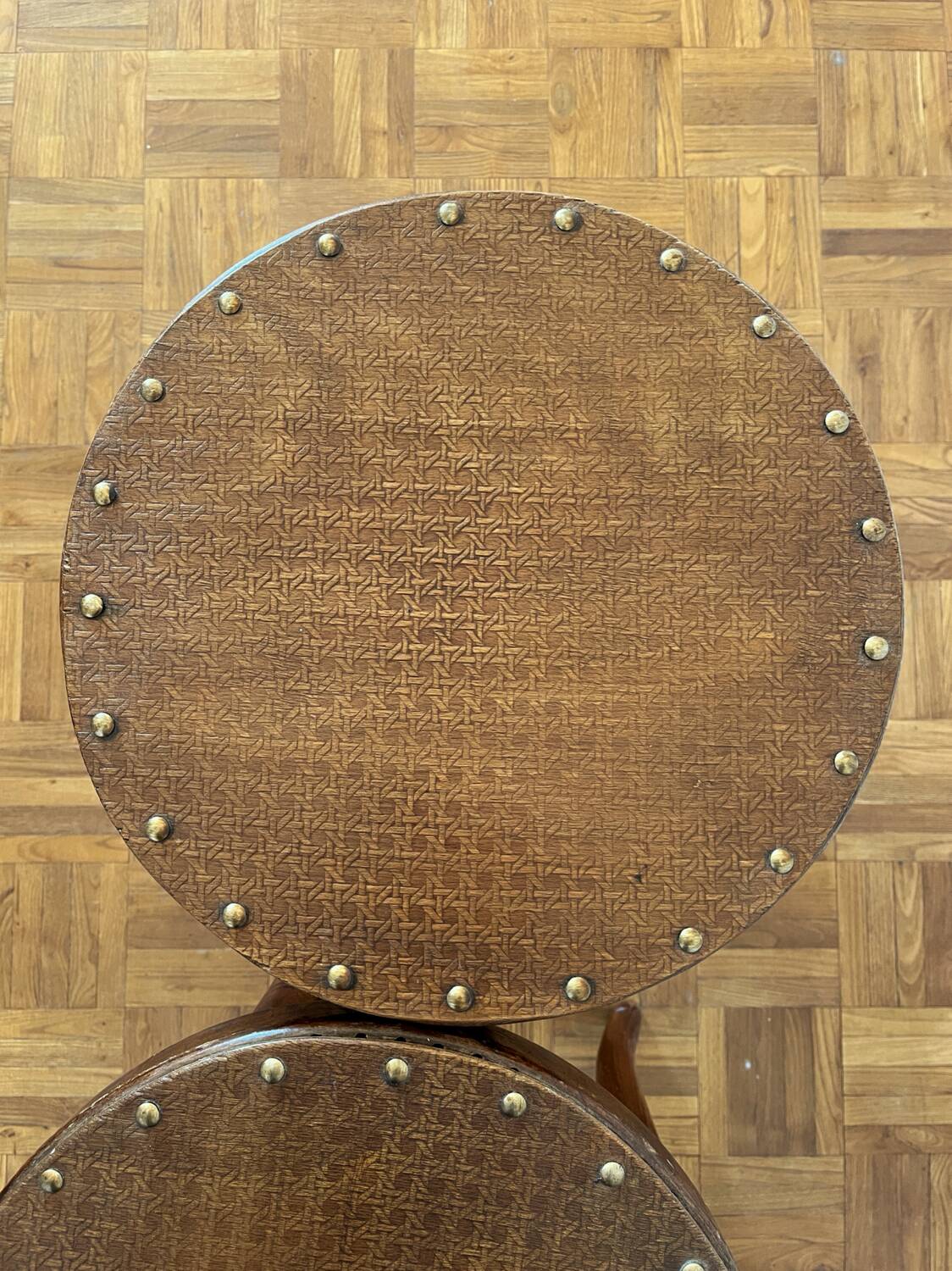 2 antique bistro stools with curved wood and caning effect.