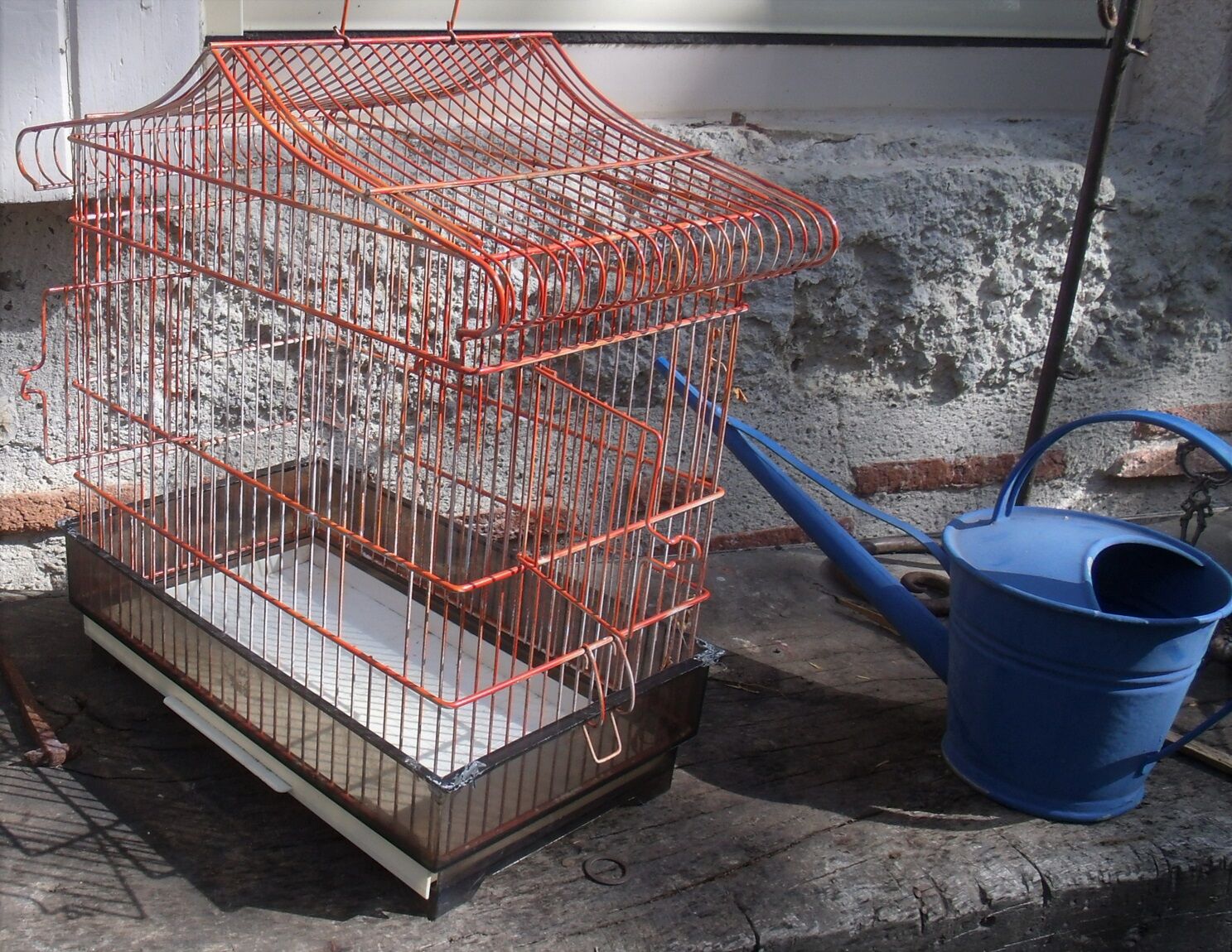 Old red metal birdcage
