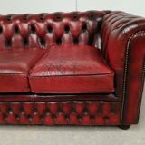 Three-seater red leather chesterfield sofa