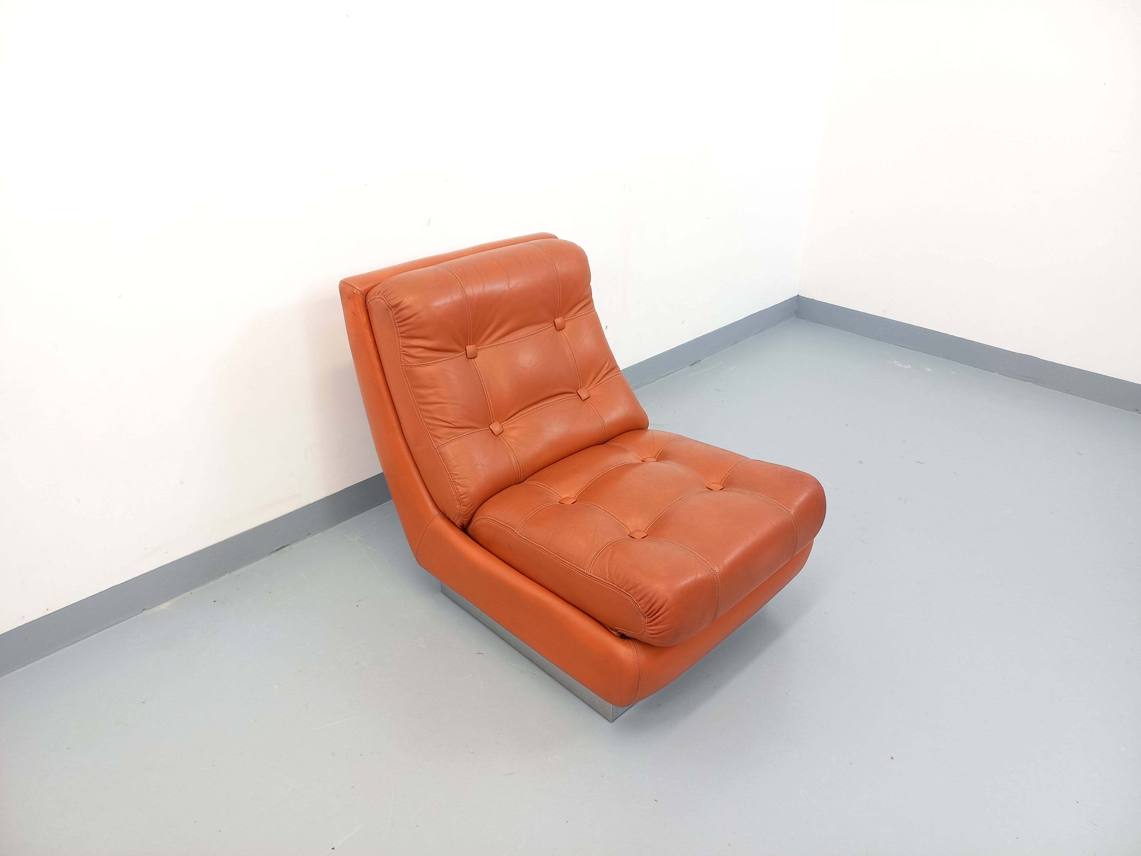 Vintage Roche Bobois armchair in chrome and terracotta leather.
