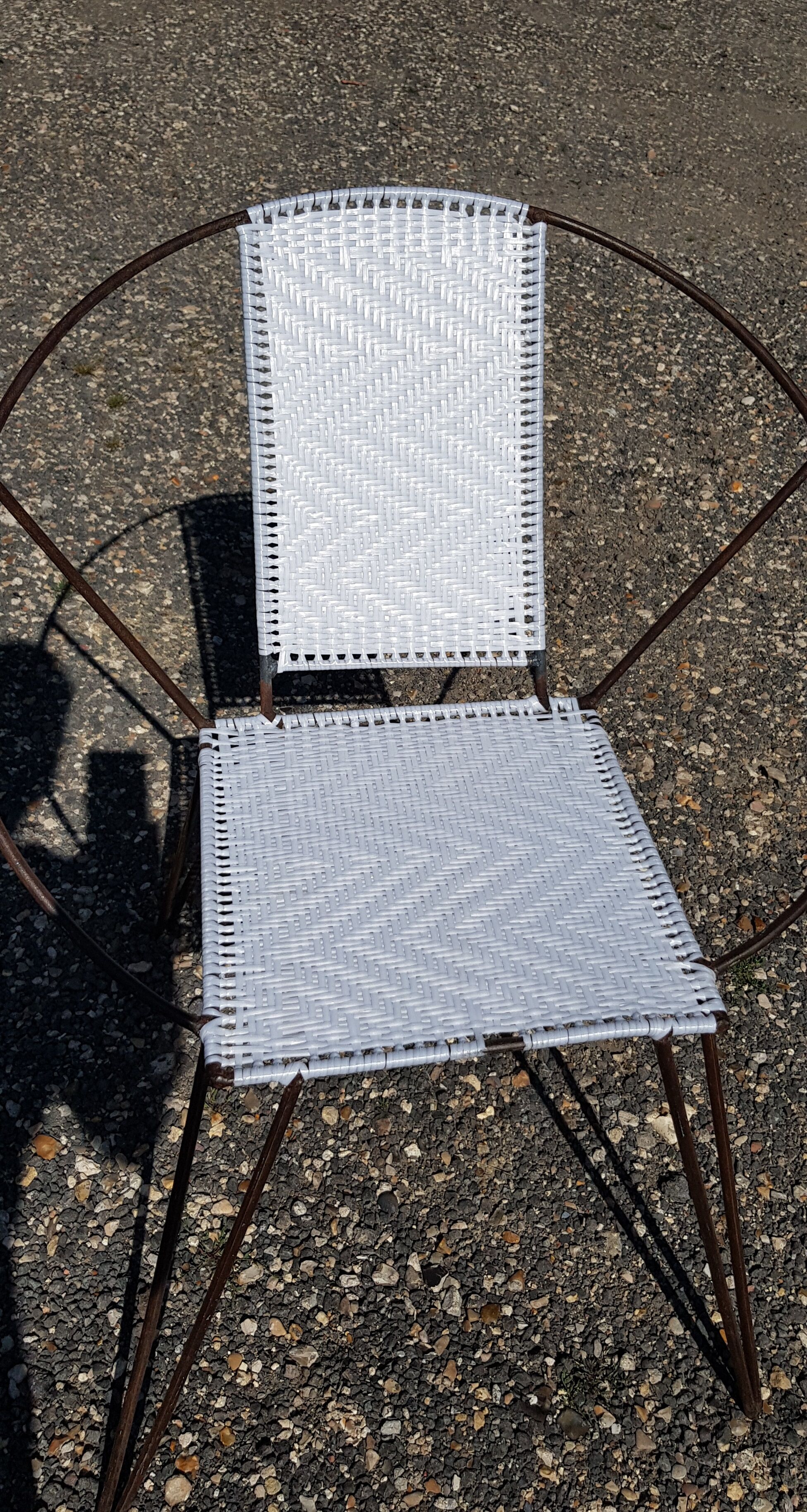 Vintage armchair in black metal and white plastic caning.