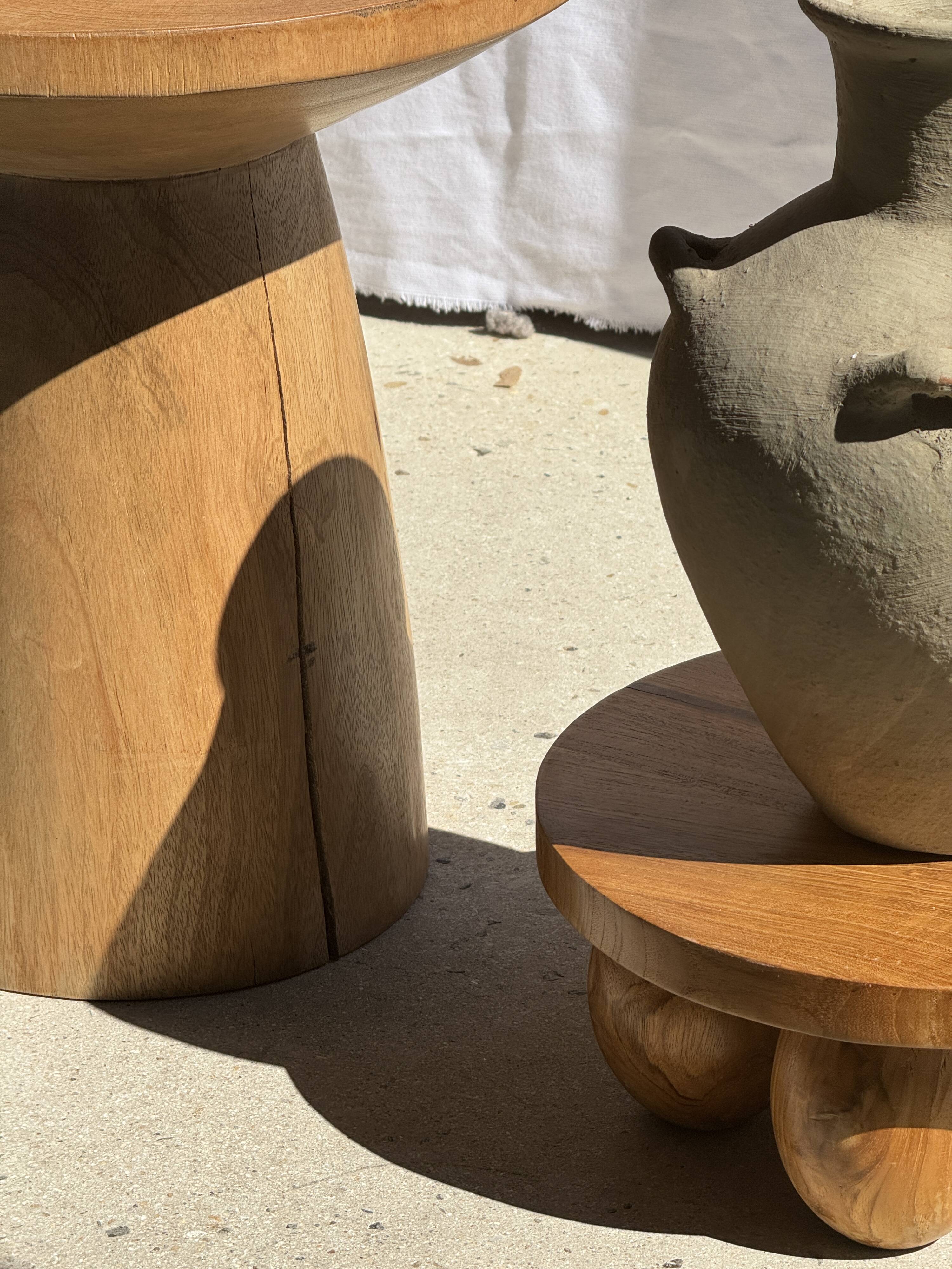 Natural solid mango side table (monoxyle) with conical legs.