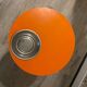 Orange tam-tam by Stamp with integrated pocket.