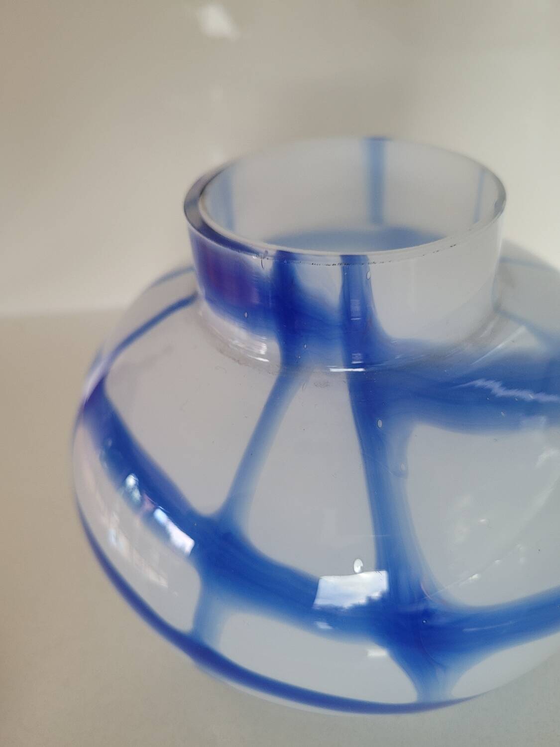 Old white and blue glass flower vase