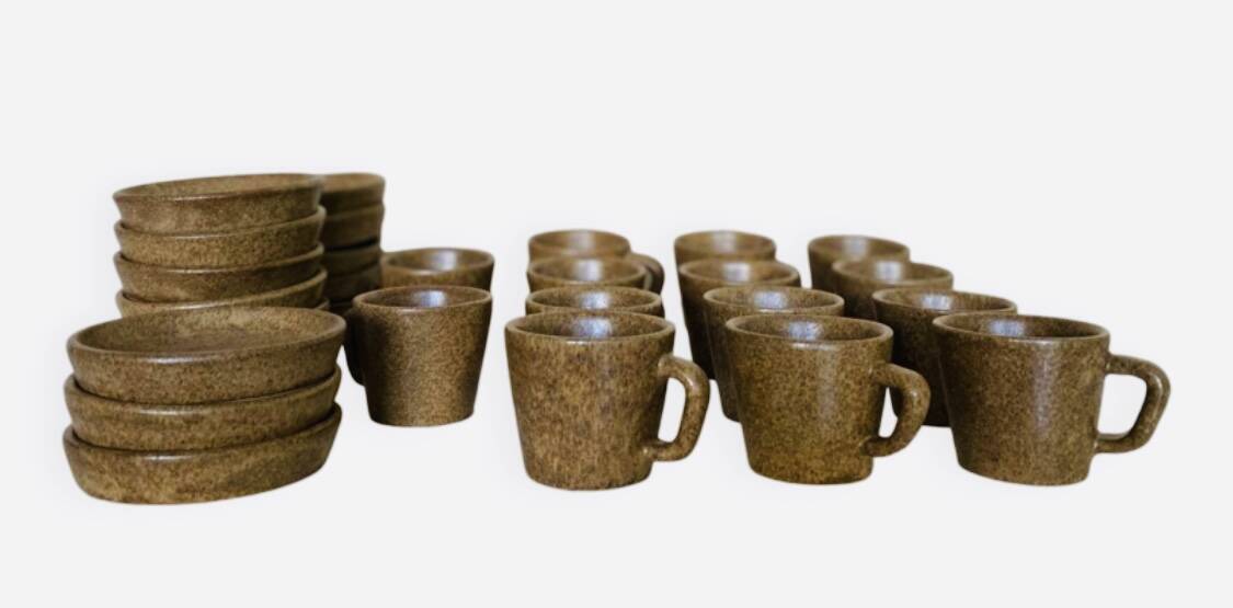 Set of stoneware coffee cups with saucers.