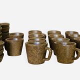 Set of stoneware coffee cups with saucers.