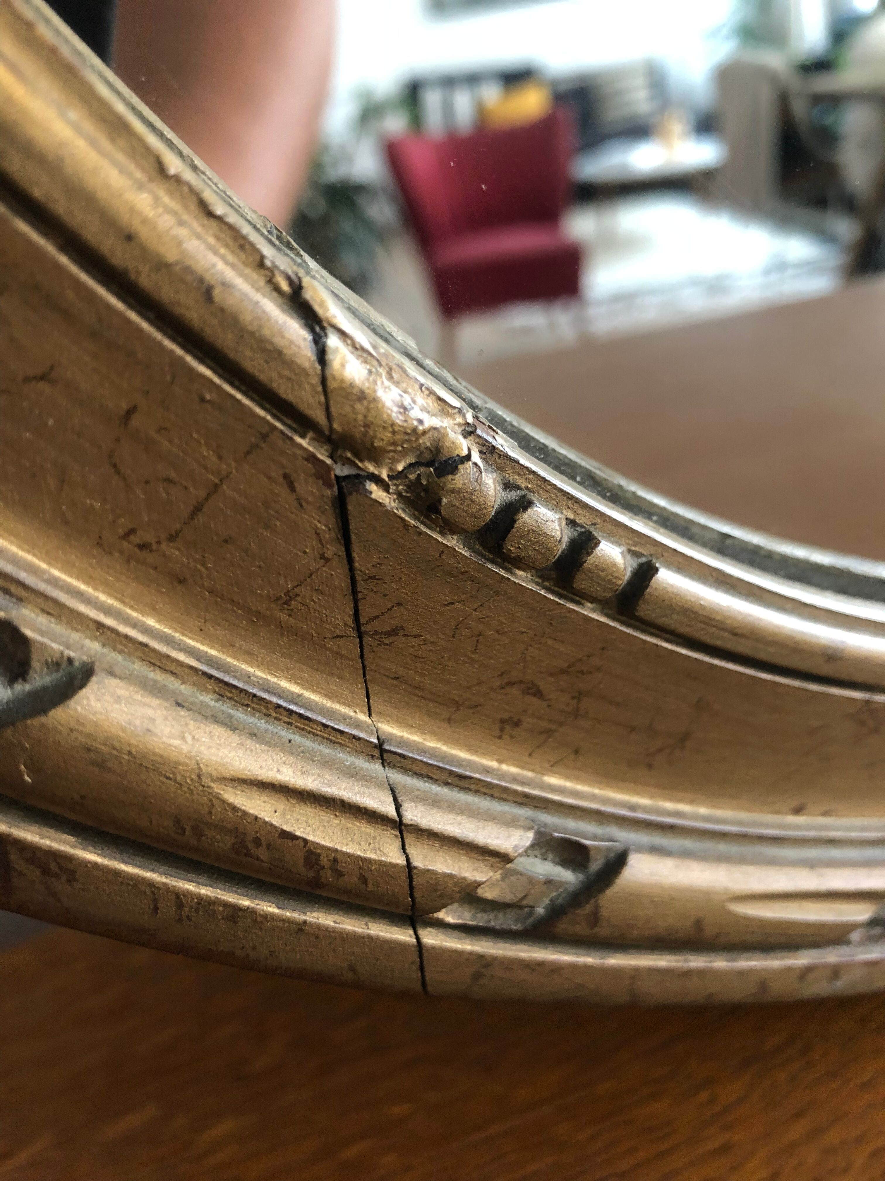 Old oval mirror with a pediment