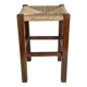 Vintage stool in dark wood with a woven straw seat.