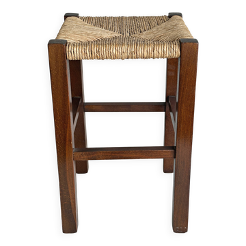 Vintage stool in dark wood with a woven straw seat.