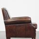 Dark brown sheepskin armchair finished with decorative nails