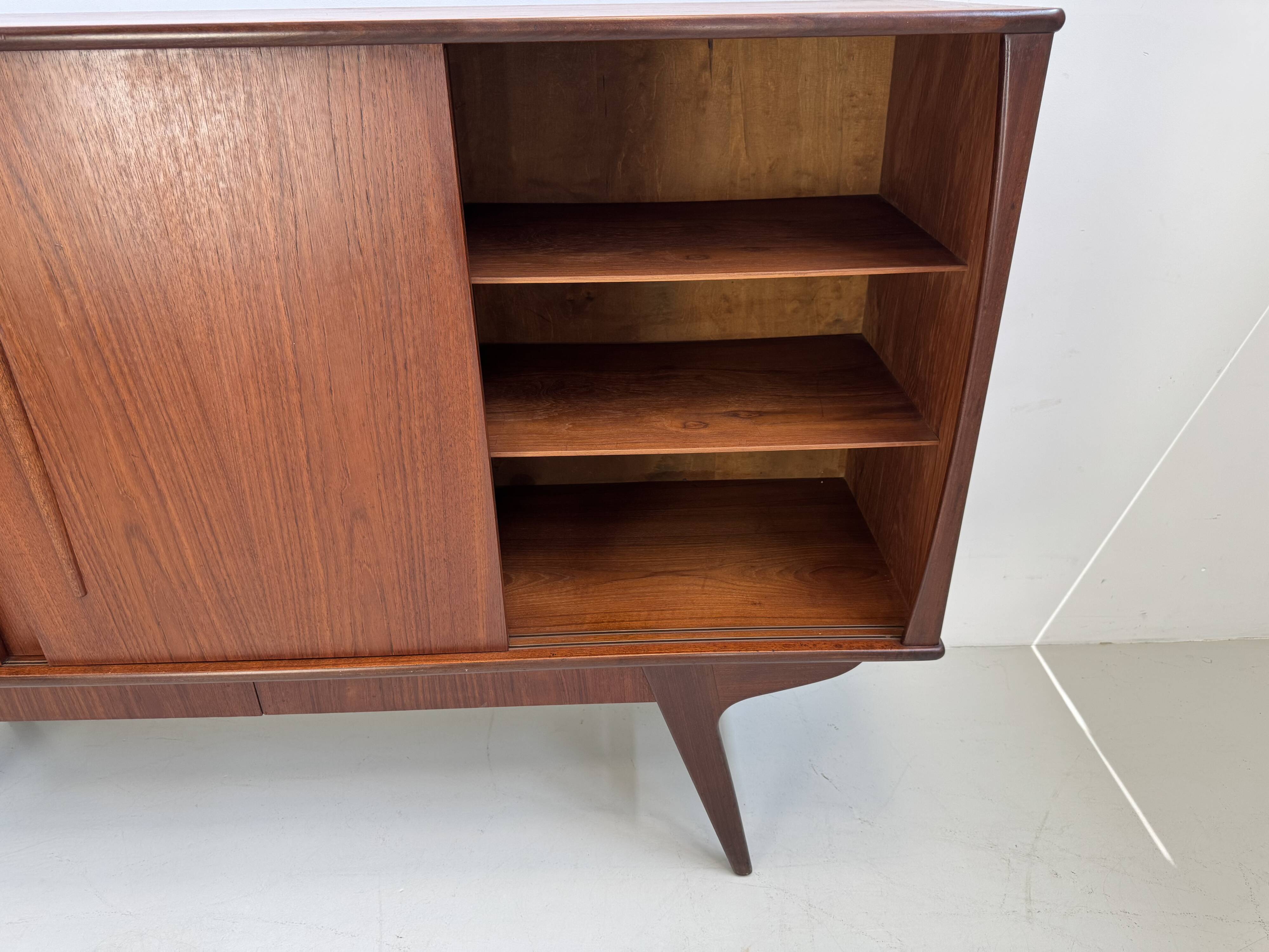 Vintage Danish teak wall unit with sliding doors from the 1960s.