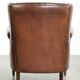 Subtle dark brown sheepskin wingback armchair with a timeless look subtle