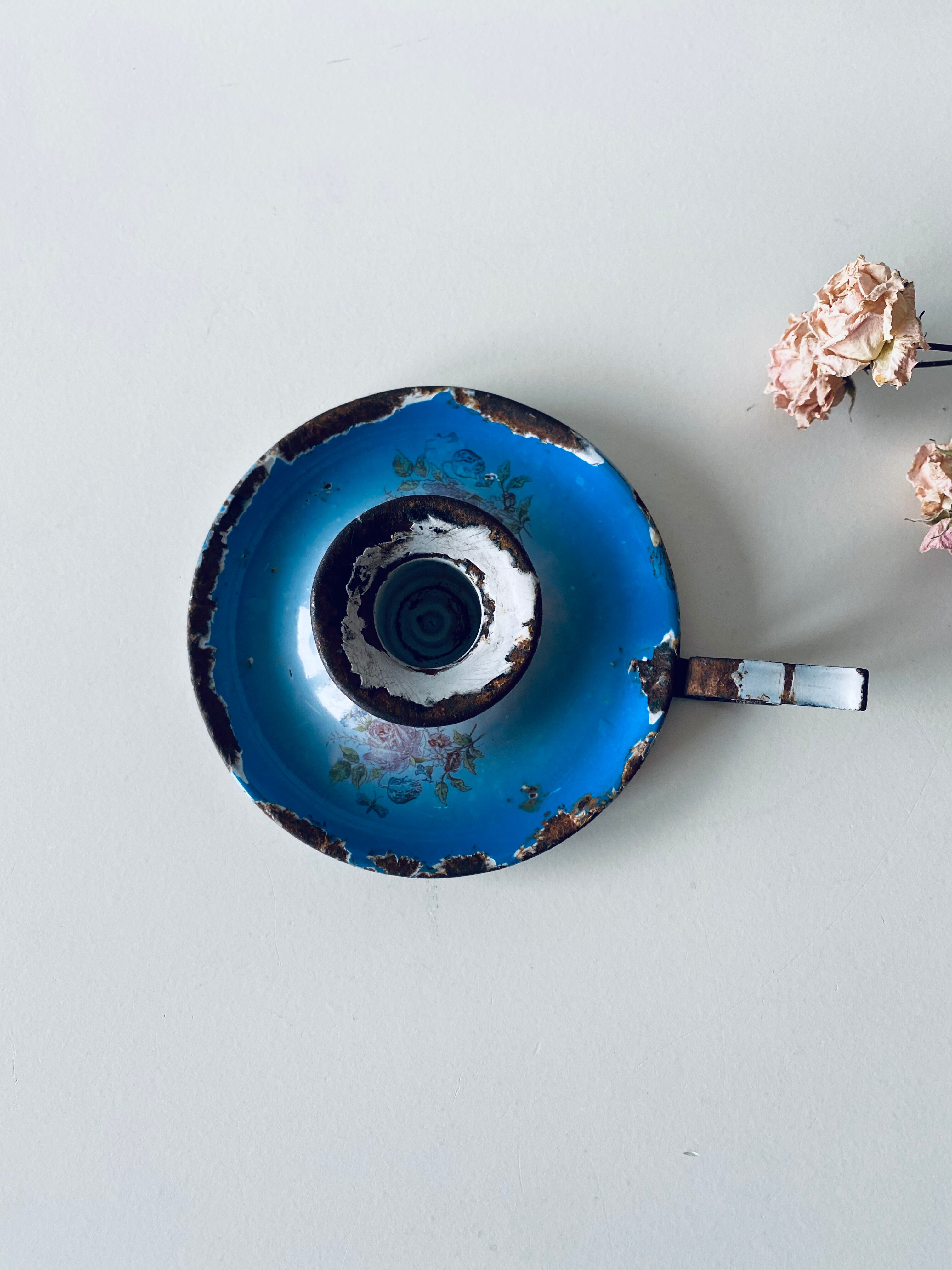 Old enamelled metal candlestick