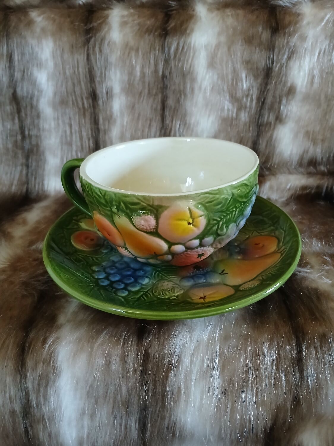 Antique cup and saucer in slipware.