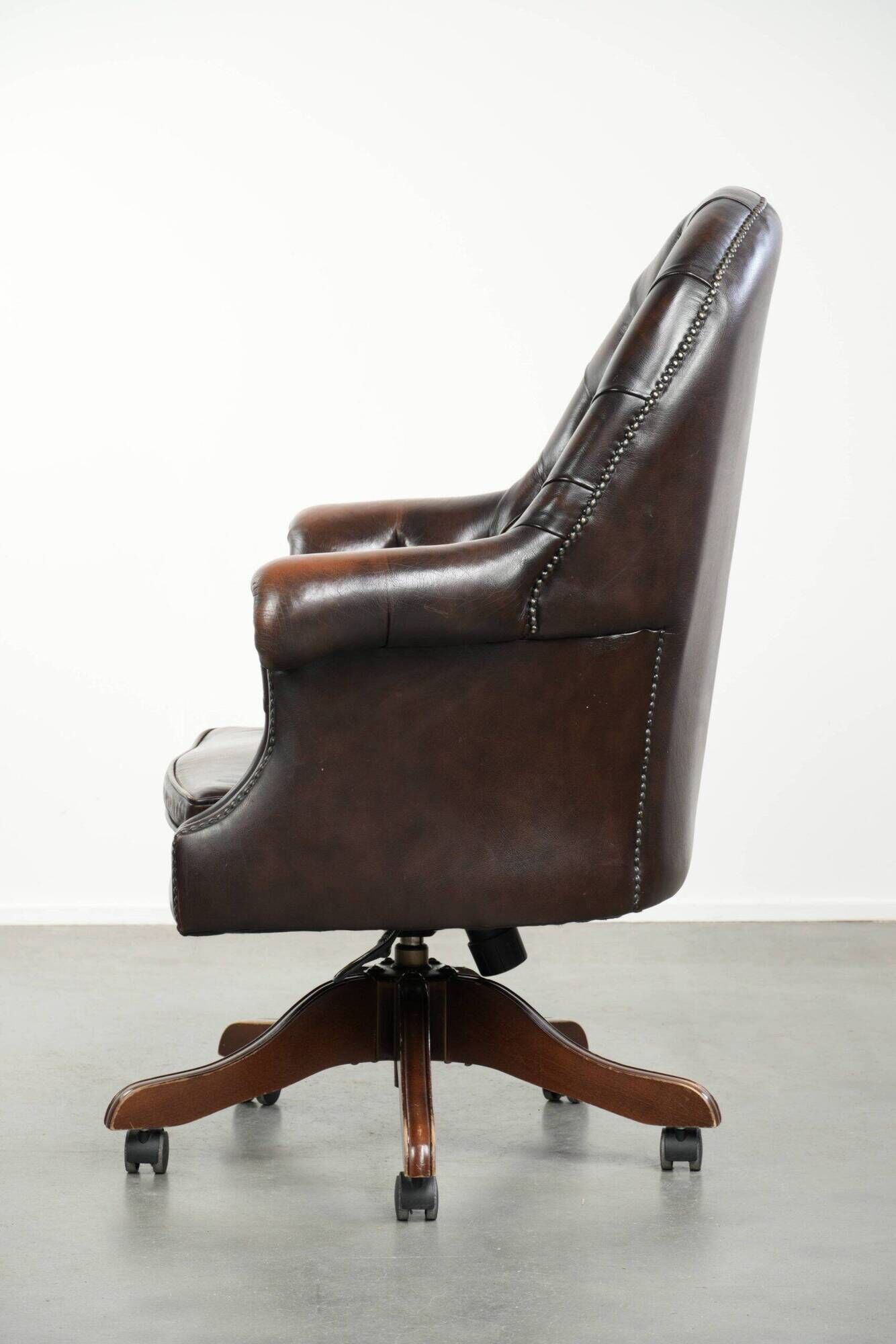 Brown cow leather Chesterfield office chair on wheels in English style