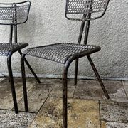Pairs of perforated metal chairs by René Malaval