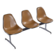 Tandem bench with brown Naugahyde pad shell chairs by Charles and Ray Eames for Herman Miller