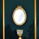 Antique oval mirror in gilded resin with Louis XVI style knot decoration