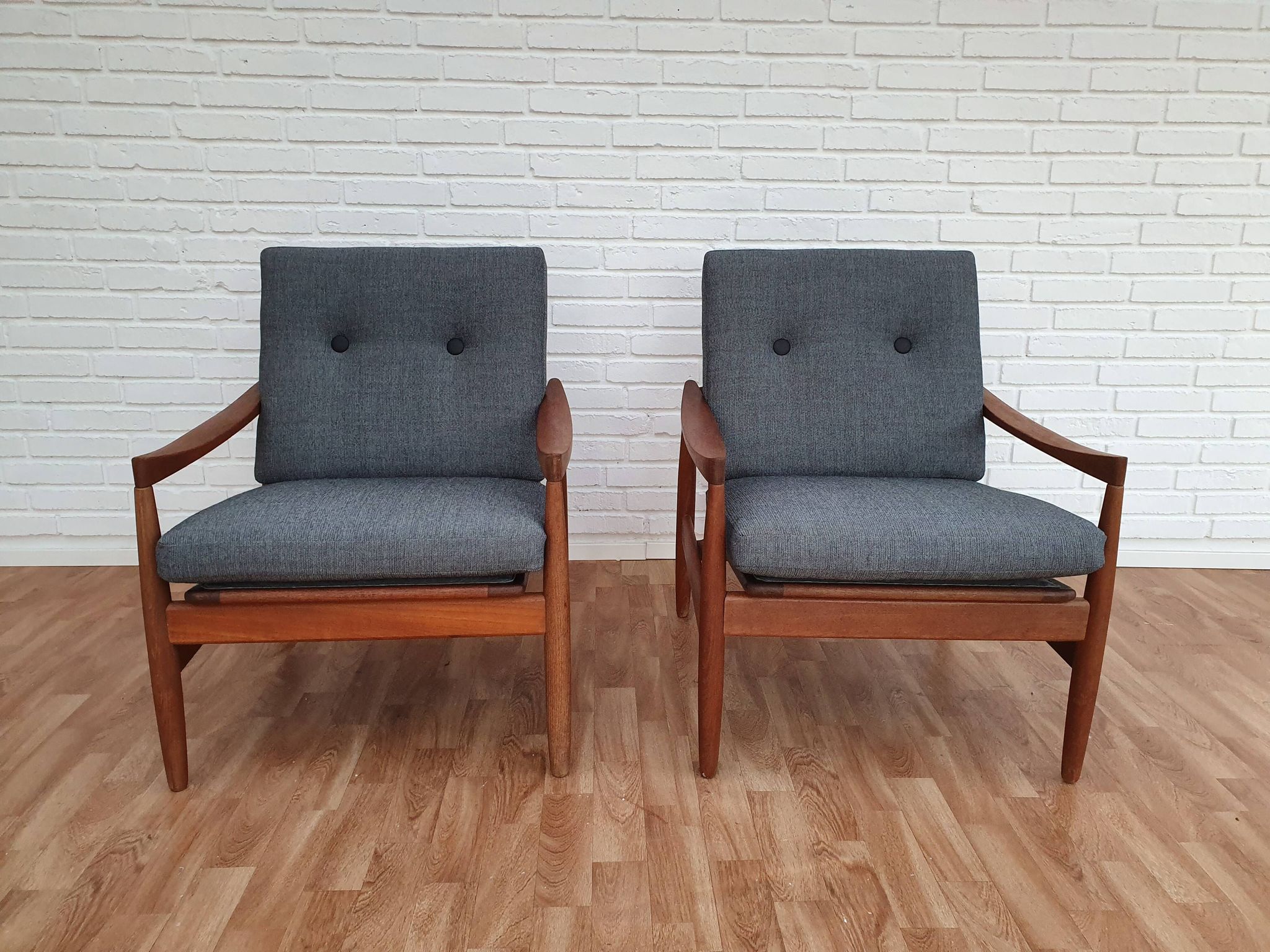 A pair of Danish armchairs, teak, wool, leather
