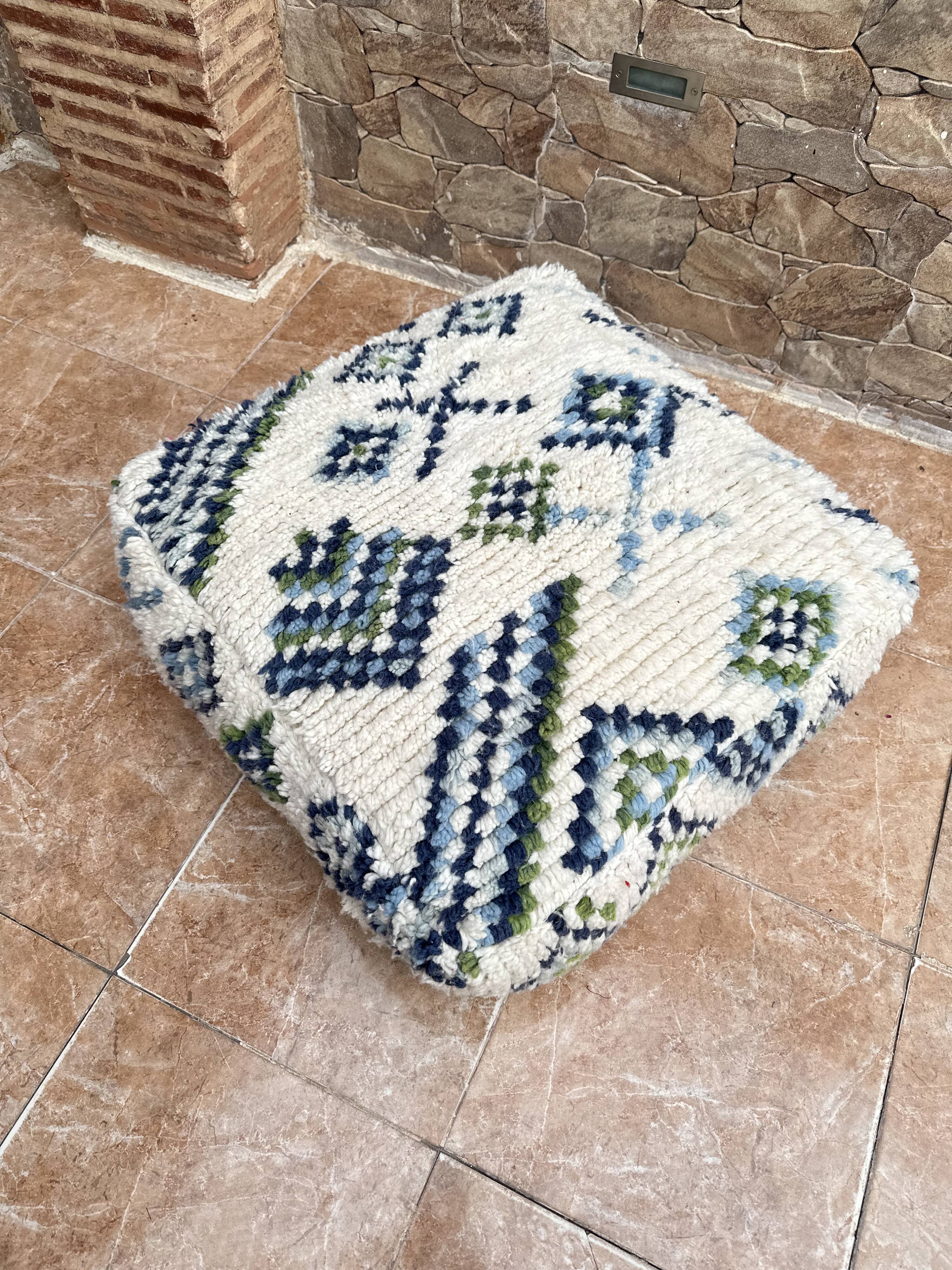 Berber floor pouf: Handwoven Moroccan wool cushion.