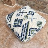 Berber floor pouf: Handwoven Moroccan wool cushion.