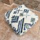 Berber floor pouf: Handwoven Moroccan wool cushion.