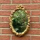 Small vintage oval wall mirror in varnished gold resin