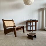 Reclined armchair in canned teak in natural wood