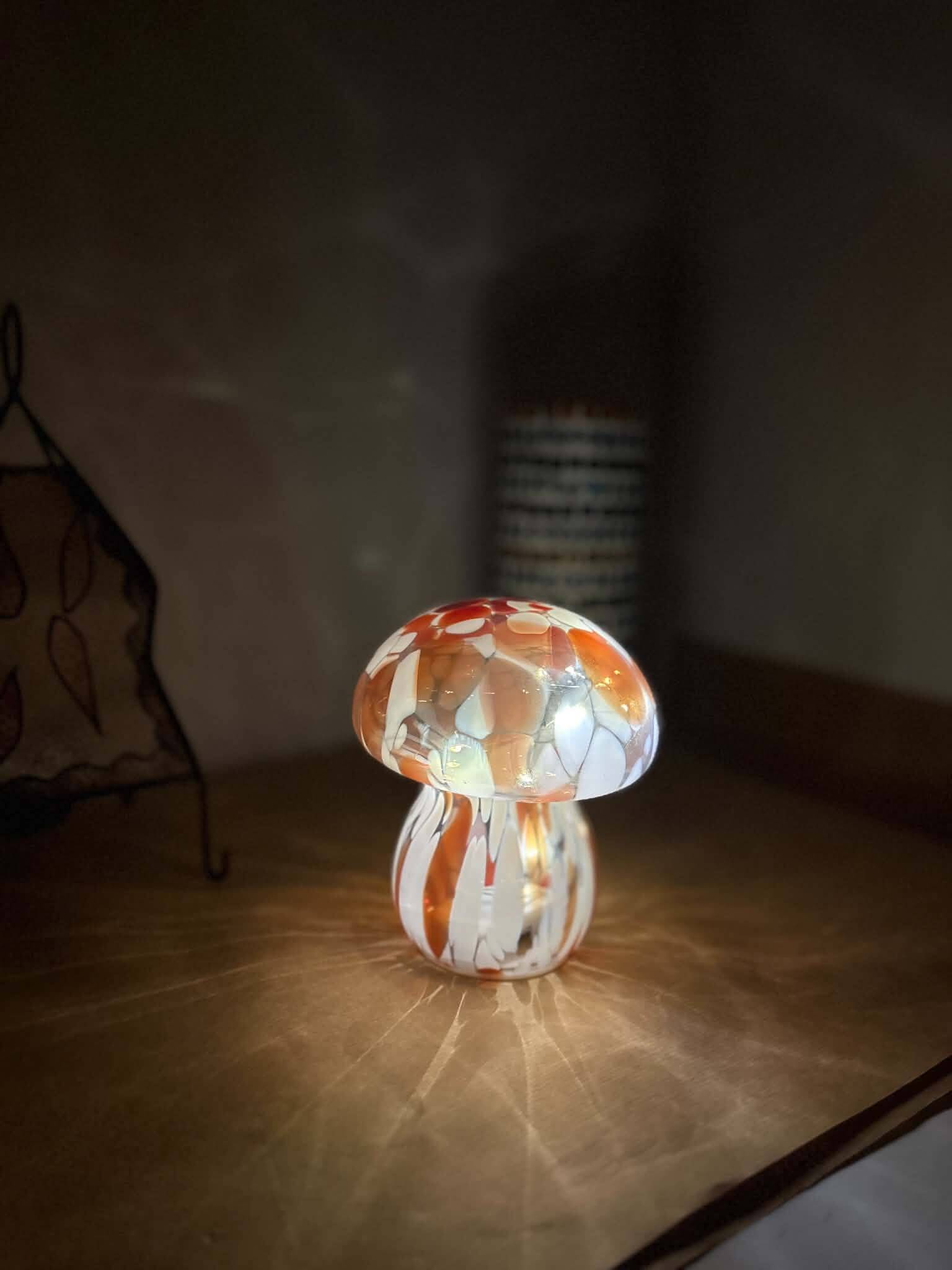 Mosaic glass mushroom lamp in orange, white, and clear.