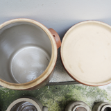 Collection of old sandstone pots with grease and mustard salting
