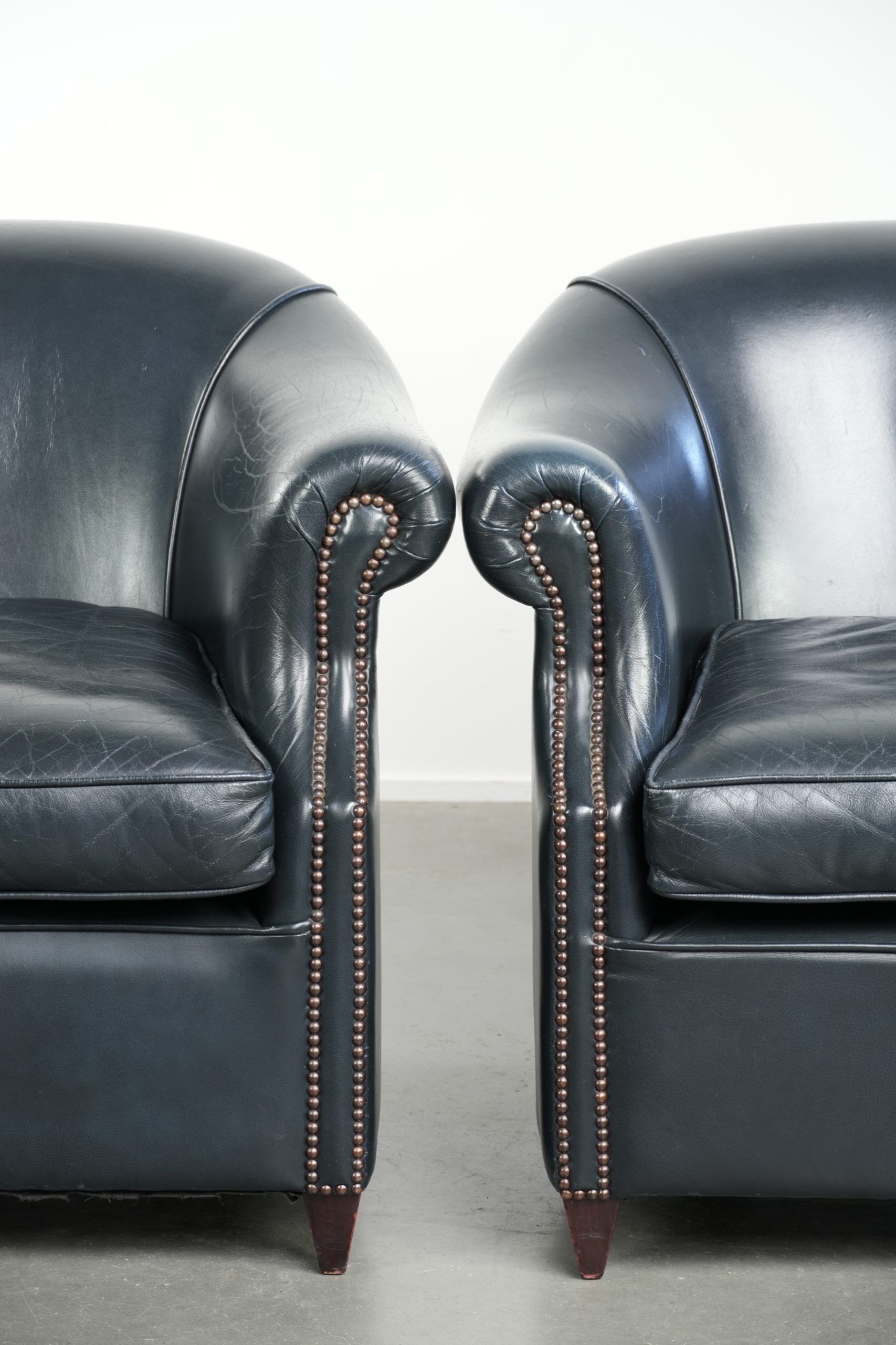 Set of dark blue cow leather club armchairs with a unique design