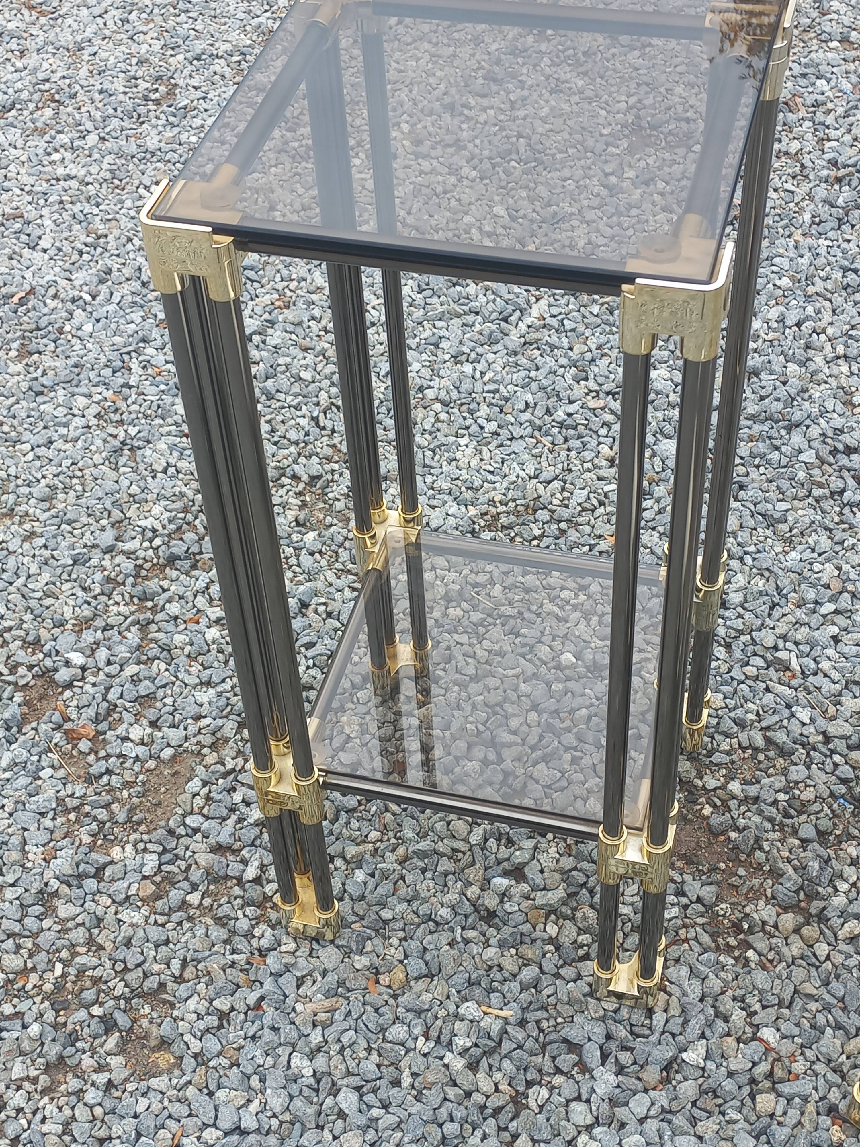 Pair of Hollywood Regency side tables in gold metal and smoked glass.