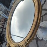 Ovoid mirror with double pediments gilded with leaf circa 1830, 105x66 cm