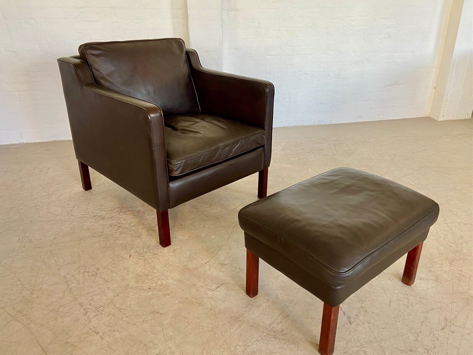 Mid-century Stouby leather lounge chair and stool in brown leather