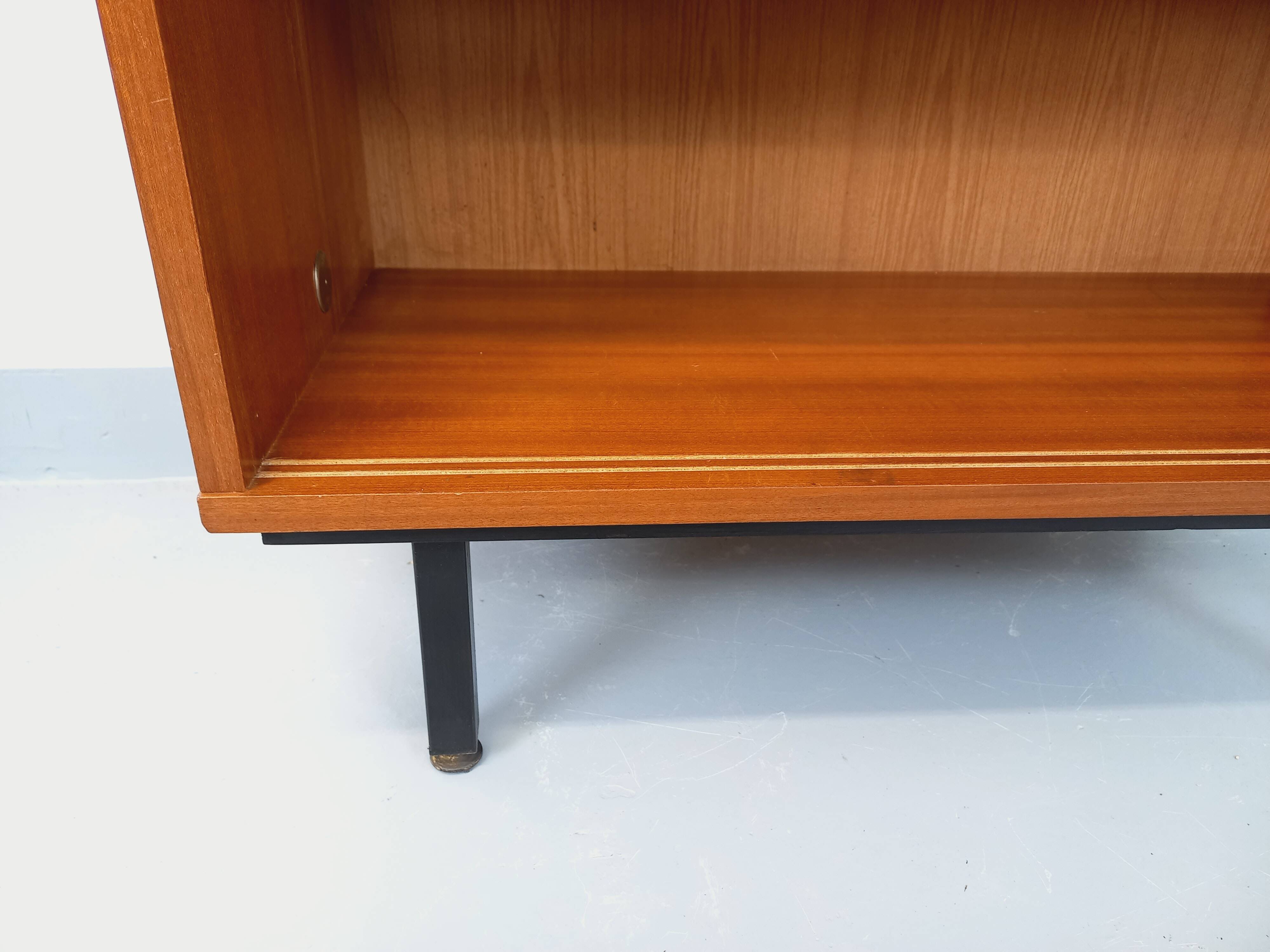 Vintage wooden bookshelf in teak style from the 1960s.