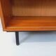 Vintage wooden bookshelf in teak style from the 1960s.