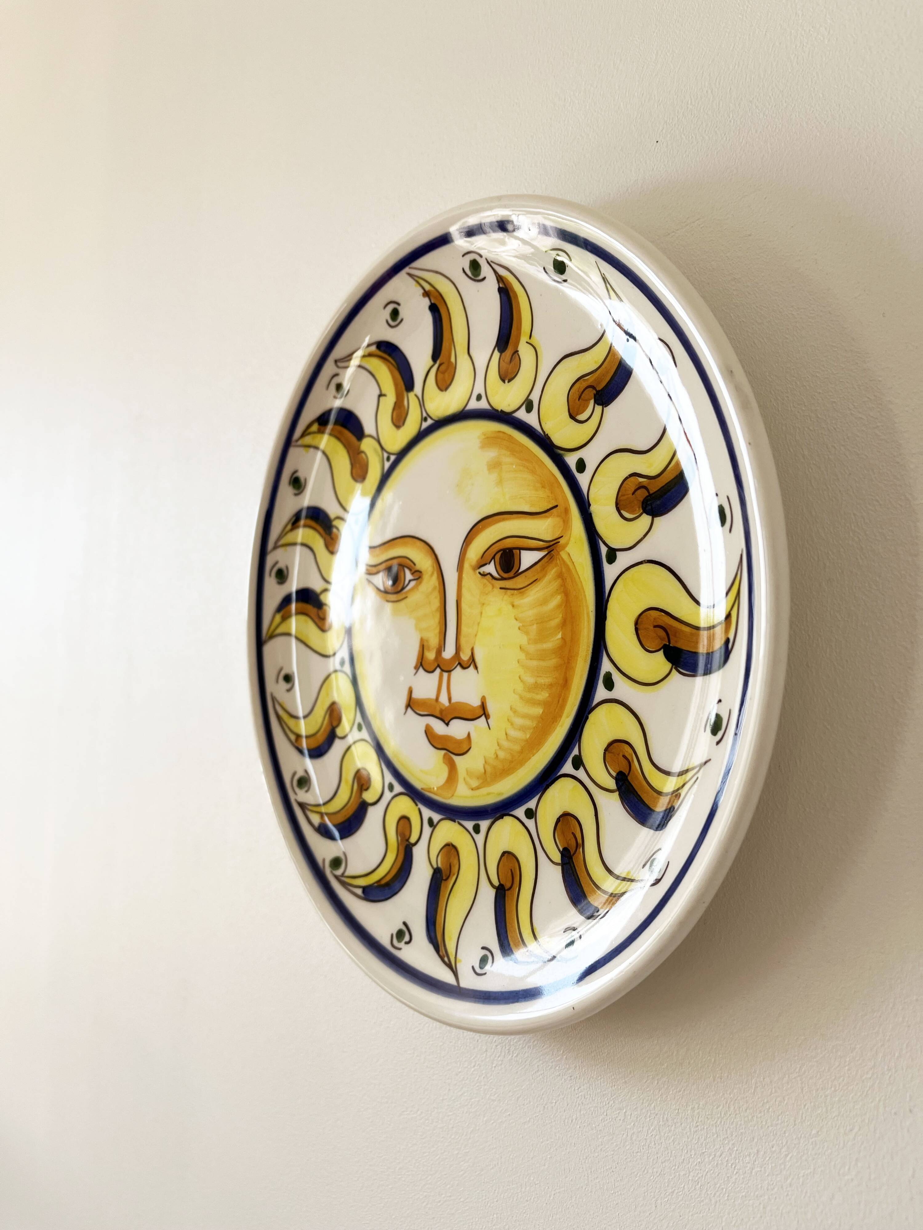Decorative ceramic plate with sun face