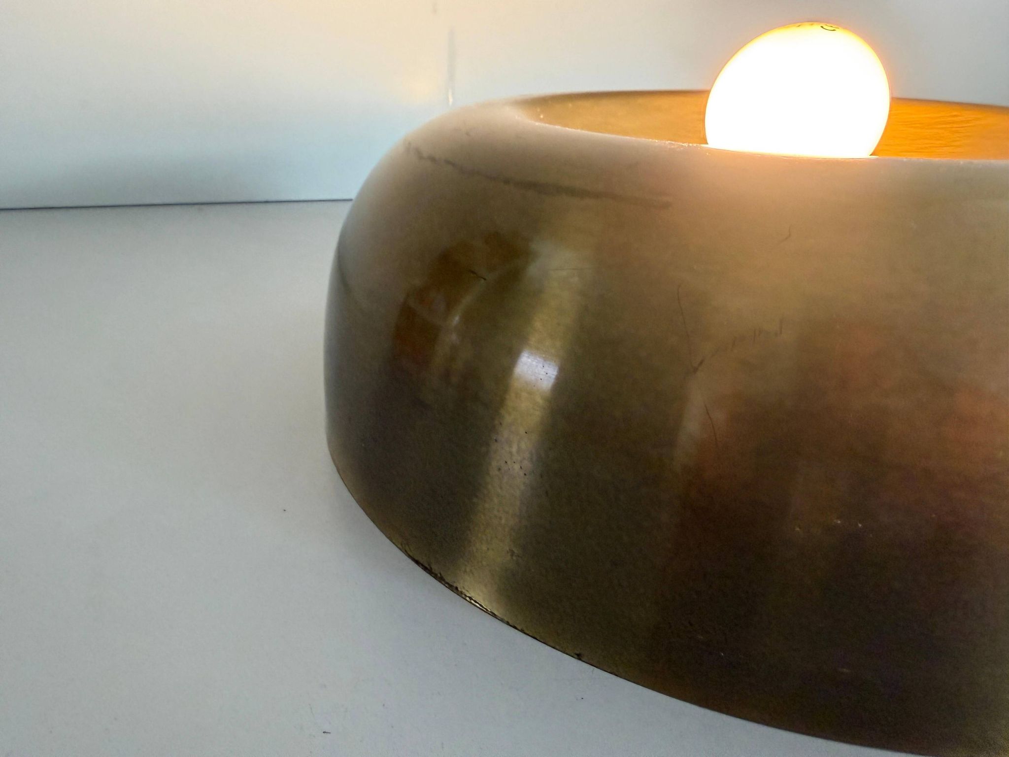 Flush-mounted disc-shaped brass fixture from the mid-century, 1960, Italy.