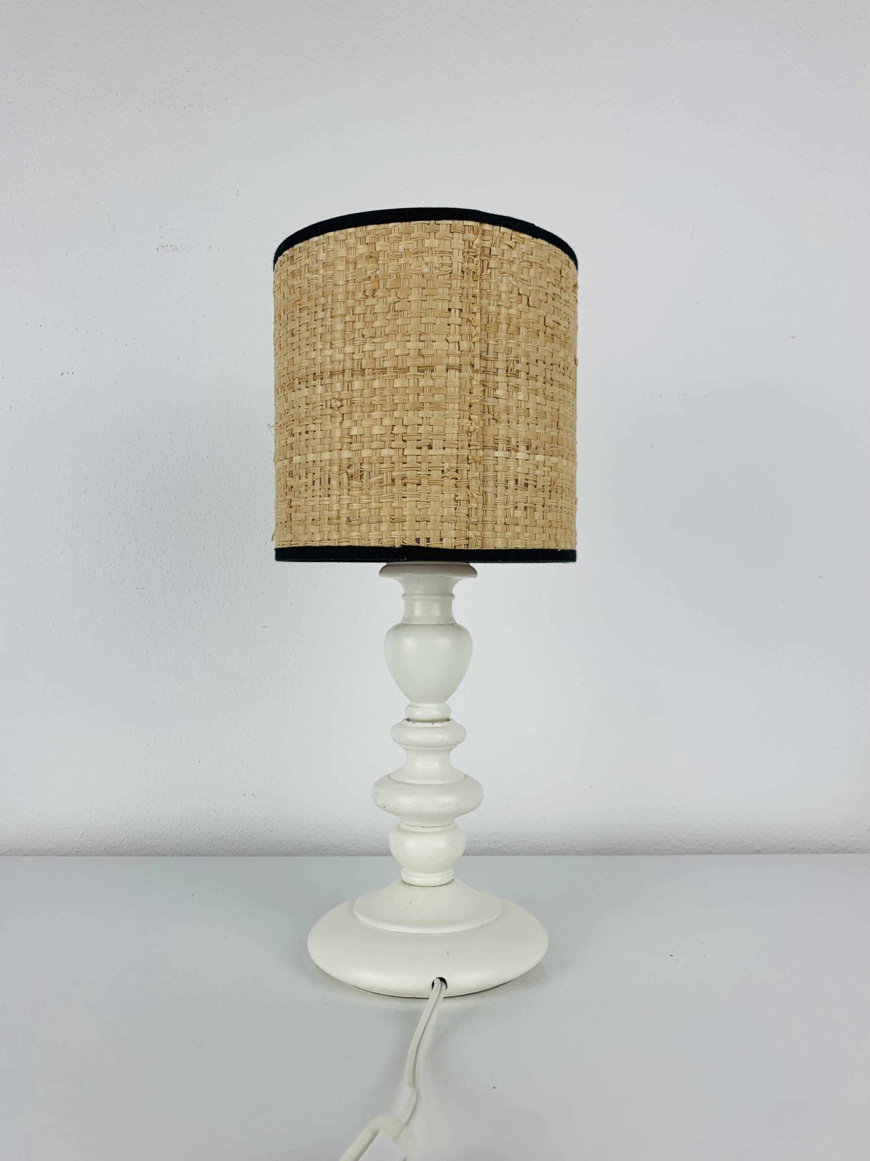 White turned wooden lamp, rattan shade, 1960s.