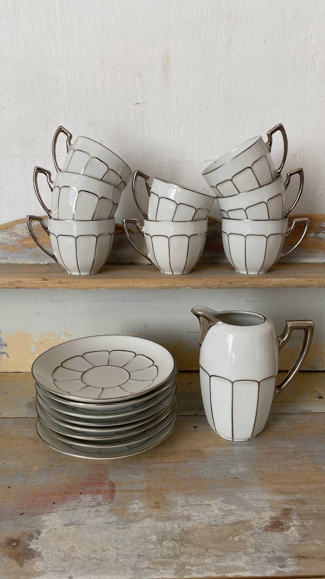 White and silver Limoges porcelain coffee cups and saucers.