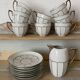 White and silver Limoges porcelain coffee cups and saucers.