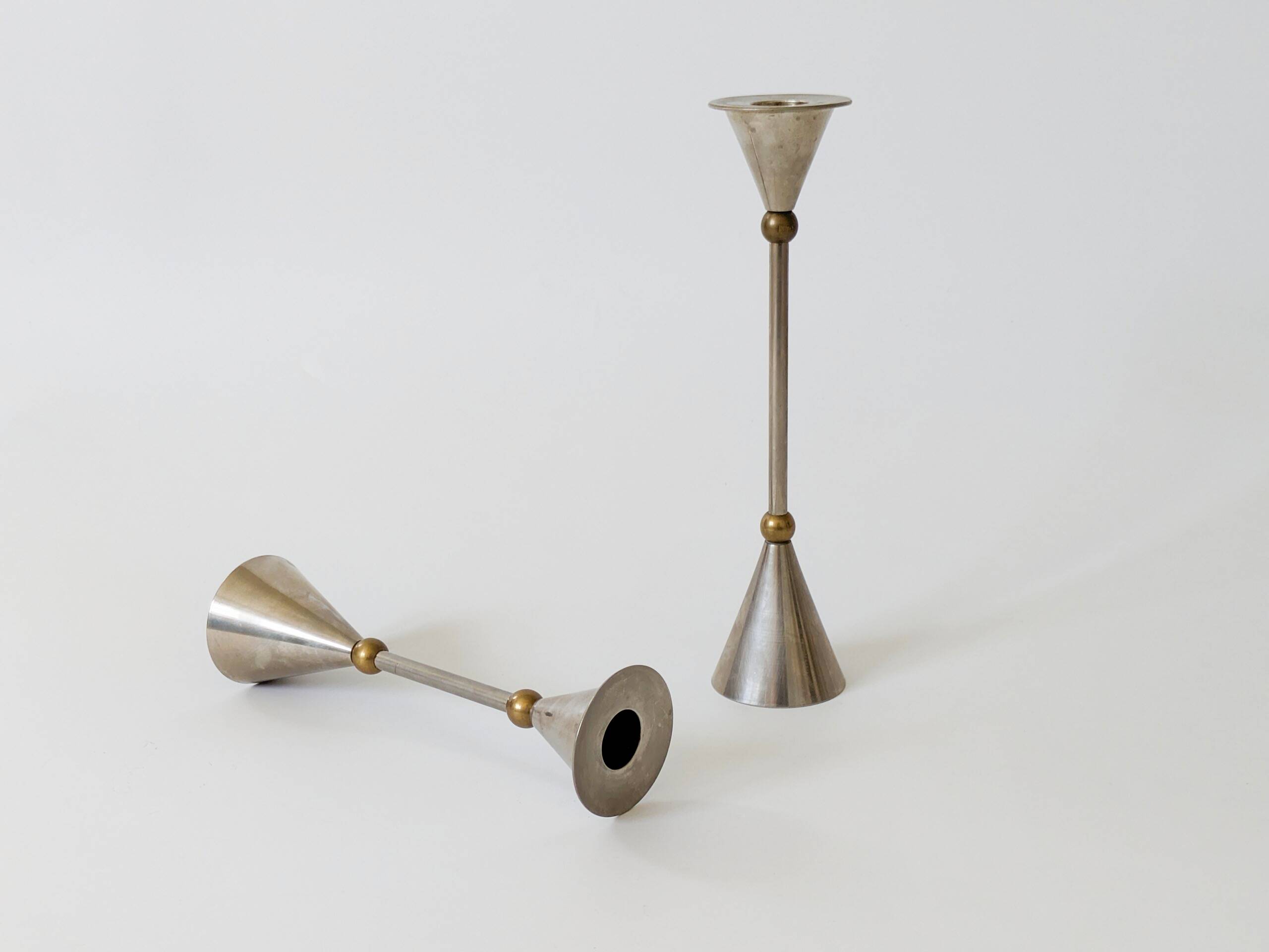 Pair of postmodern candlesticks in Memphis style made of steel and brass.