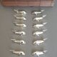 Lot 12 knife holders in the shape of a stylized whale or fish